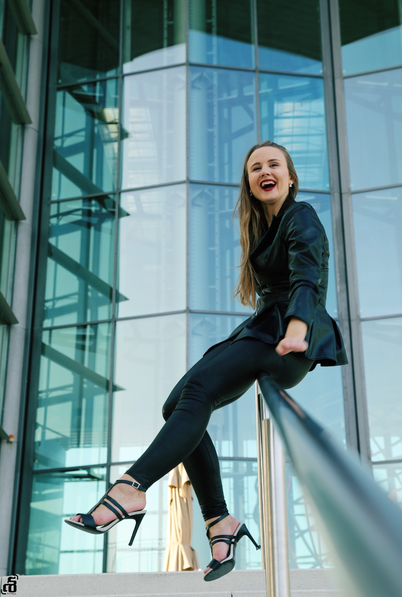 Monochrome fashion portrait, seated on architectural steps
